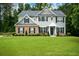 Charming two-story home with manicured lawn, gray siding, and brick accents, offering timeless curb appeal at 325 Paces Dr, Lithia Springs, GA 30122