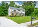 Well-maintained home with lush green lawn, beautiful landscaping, and inviting driveway, exuding suburban charm at 325 Paces Dr, Lithia Springs, GA 30122
