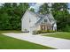 Traditional home exterior with a manicured lawn, brick accents, and an attached two-car garage at 325 Paces Dr, Lithia Springs, GA 30122