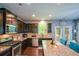 Spacious kitchen features stainless appliances, granite counters, and a breakfast bar plus access to outdoor patio at 325 Paces Dr, Lithia Springs, GA 30122