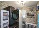 Convenient laundry room with modern washer/dryer, brick accent wall, and storage at 325 Paces Dr, Lithia Springs, GA 30122