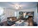 Spacious living room with hardwood floors and a view of the kitchen at 325 Paces Dr, Lithia Springs, GA 30122