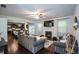 Open-concept living room with fireplace, ceiling fan, and seamless flow to kitchen at 325 Paces Dr, Lithia Springs, GA 30122