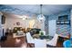 Open concept living area with modern chandelier and brick accent wall flows from a gourmet kitchen at 325 Paces Dr, Lithia Springs, GA 30122