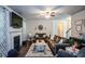 Cozy living room featuring a fireplace, ceiling fan, and dark hardwood floors at 325 Paces Dr, Lithia Springs, GA 30122