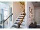 Elegant staircase with stained wood handrail and white risers at 325 Paces Dr, Lithia Springs, GA 30122