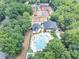 Expansive aerial view of community pool and tennis courts surrounded by lush greenery and manicured lawns at 4157 Berkeley Nw Lndg, Kennesaw, GA 30144