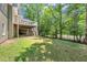 Spacious backyard featuring a wooden deck, green lawn, mature trees, and shaded patio area at 4157 Berkeley Nw Lndg, Kennesaw, GA 30144