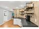 Basement wet bar with a black countertop, white cabinets and wood-look floor at 4157 Berkeley Nw Lndg, Kennesaw, GA 30144