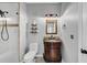 Bathroom featuring a vanity with a granite countertop, framed mirror, and glass shower at 4157 Berkeley Nw Lndg, Kennesaw, GA 30144