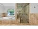 Bright bathroom features a soaking tub and glass enclosed walk-in shower at 4157 Berkeley Nw Lndg, Kennesaw, GA 30144