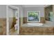 Bathroom with a standalone tub, travertine tile and glass enclosed shower at 4157 Berkeley Nw Lndg, Kennesaw, GA 30144