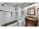 Bathroom featuring a vanity with a granite countertop, framed mirror, and glass shower at 4157 Berkeley Nw Lndg, Kennesaw, GA 30144