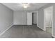 Spacious carpeted bedroom with a ceiling fan and two doorways offering ample closet space and bright lighting at 4157 Berkeley Nw Lndg, Kennesaw, GA 30144