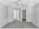 Spacious carpeted bedroom with a ceiling fan, closet access, and a doorway to another room at 4157 Berkeley Nw Lndg, Kennesaw, GA 30144