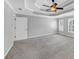 Bright bedroom with a fan, tray ceiling, carpet, and windows with shutter blinds at 4157 Berkeley Nw Lndg, Kennesaw, GA 30144