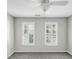 Bedroom with neutral walls and a ceiling fan below two windows with white wood shutter blinds at 4157 Berkeley Nw Lndg, Kennesaw, GA 30144