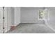 Spacious carpeted bedroom with a side window and open door to another room with a tiled floor at 4157 Berkeley Nw Lndg, Kennesaw, GA 30144