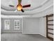 Bedroom with a trey ceiling and fan, a sliding barn door to the bathroom and bright windows at 4157 Berkeley Nw Lndg, Kennesaw, GA 30144