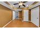 Well-lit bedroom with hardwood floors, ceiling fan, closet space, and fresh paint at 4157 Berkeley Nw Lndg, Kennesaw, GA 30144