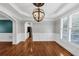 Open dining room with modern chandelier, shuttered windows, and hardwood floors at 4157 Berkeley Nw Lndg, Kennesaw, GA 30144