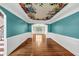 Elegant dining room with floral ceiling decor, hardwood floors, and wall trim at 4157 Berkeley Nw Lndg, Kennesaw, GA 30144