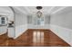 Open dining room with modern chandelier, shuttered windows, and hardwood floors at 4157 Berkeley Nw Lndg, Kennesaw, GA 30144
