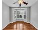 Bright, empty room with hardwood floors, neutral walls and bay window with shutters at 4157 Berkeley Nw Lndg, Kennesaw, GA 30144