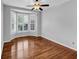 Bright, empty room with hardwood floors, neutral walls and bay window with shutters at 4157 Berkeley Nw Lndg, Kennesaw, GA 30144
