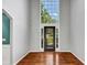 Bright foyer featuring a large window, hardwood floors, and modern gray walls at 4157 Berkeley Nw Lndg, Kennesaw, GA 30144