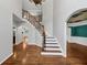 Spacious foyer featuring staircase, hardwood floors, and archway at 4157 Berkeley Nw Lndg, Kennesaw, GA 30144