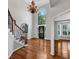 Bright foyer featuring a staircase, hardwood floors, and modern chandelier at 4157 Berkeley Nw Lndg, Kennesaw, GA 30144