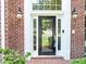 Elegant front door with glass panel, sidelights, and classic brick surround at 4157 Berkeley Nw Lndg, Kennesaw, GA 30144