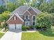 Charming brick home with manicured lawn, two-car garage, and inviting front entrance at 4157 Berkeley Nw Lndg, Kennesaw, GA 30144