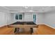 Finished game room with a billiard table, bright windows, and backyard access at 4157 Berkeley Nw Lndg, Kennesaw, GA 30144