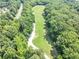 Aerial view of the community green space featuring walking trail and scenic views through the trees at 4157 Berkeley Nw Lndg, Kennesaw, GA 30144