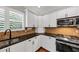 Kitchen area featuring modern appliances, granite countertops and white cabinets at 4157 Berkeley Nw Lndg, Kennesaw, GA 30144