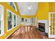 Vaulted living room with bright yellow walls, fireplace and beautiful hardwood flooring at 4157 Berkeley Nw Lndg, Kennesaw, GA 30144