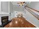Living room with stairs, fireplace and an open floor plan leading to the kitchen at 4157 Berkeley Nw Lndg, Kennesaw, GA 30144