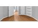 A clean room with light wood floors, gray walls, and white trim at 4157 Berkeley Nw Lndg, Kennesaw, GA 30144