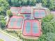 Aerial view of multiple tennis courts, featuring well-maintained green playing surfaces surrounded by red perimeter at 4157 Berkeley Nw Lndg, Kennesaw, GA 30144