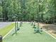 Outdoor workout space equipped with various exercise machines, surrounded by trees at 4157 Berkeley Nw Lndg, Kennesaw, GA 30144