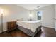 Cozy bedroom features hardwood floors, natural light, and a warm and inviting ambiance at 2801 Holly Oaks Dr, Marietta, GA 30062