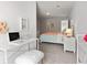 Bright room with white desk, comfortable bed, white night stand and light gray walls at 3820 Near Star Ln, Cumming, GA 30028