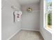 Compact walk-in closet with simple shelving and a t-shirt hanging at 3820 Near Star Ln, Cumming, GA 30028