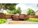 A backyard view with a wooden deck, fenced yard, lush greenery, and a charming gazebo in the background at 4978 Arborview Pkwy, Acworth, GA 30101