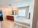 Bright bathroom featuring a soaking tub with a window and a double sink vanity at 4978 Arborview Pkwy, Acworth, GA 30101