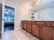 Bathroom view highlighting double-sink vanity with travertine-style tile floors and bedroom view at 4978 Arborview Pkwy, Acworth, GA 30101