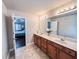 Large bathroom featuring double-sink vanity with granite counters, decorative tile flooring and bedroom view at 4978 Arborview Pkwy, Acworth, GA 30101