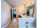 Bathroom view highlighting vanity, soaking tub, travertine-style floor tiles and bedroom view at 4978 Arborview Pkwy, Acworth, GA 30101